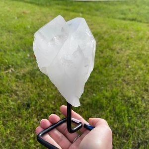 Quartz point on metal stand. (Crystals)